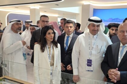 Minister Al-Meshaan inspects of one of the models of the railway projects at the exhibition.