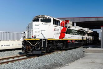 An Etihad Rail locomotive stands on the track at a rail facility in the United Arab Emirates. (Photo via etihadrail.ae)